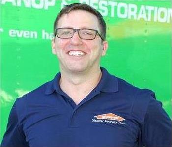 Bryce Clark Owner SERVPRO Arlington, male with blue shirt and glasses