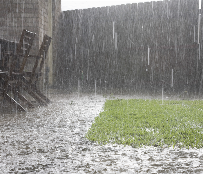 Heavy rain in a front yard.